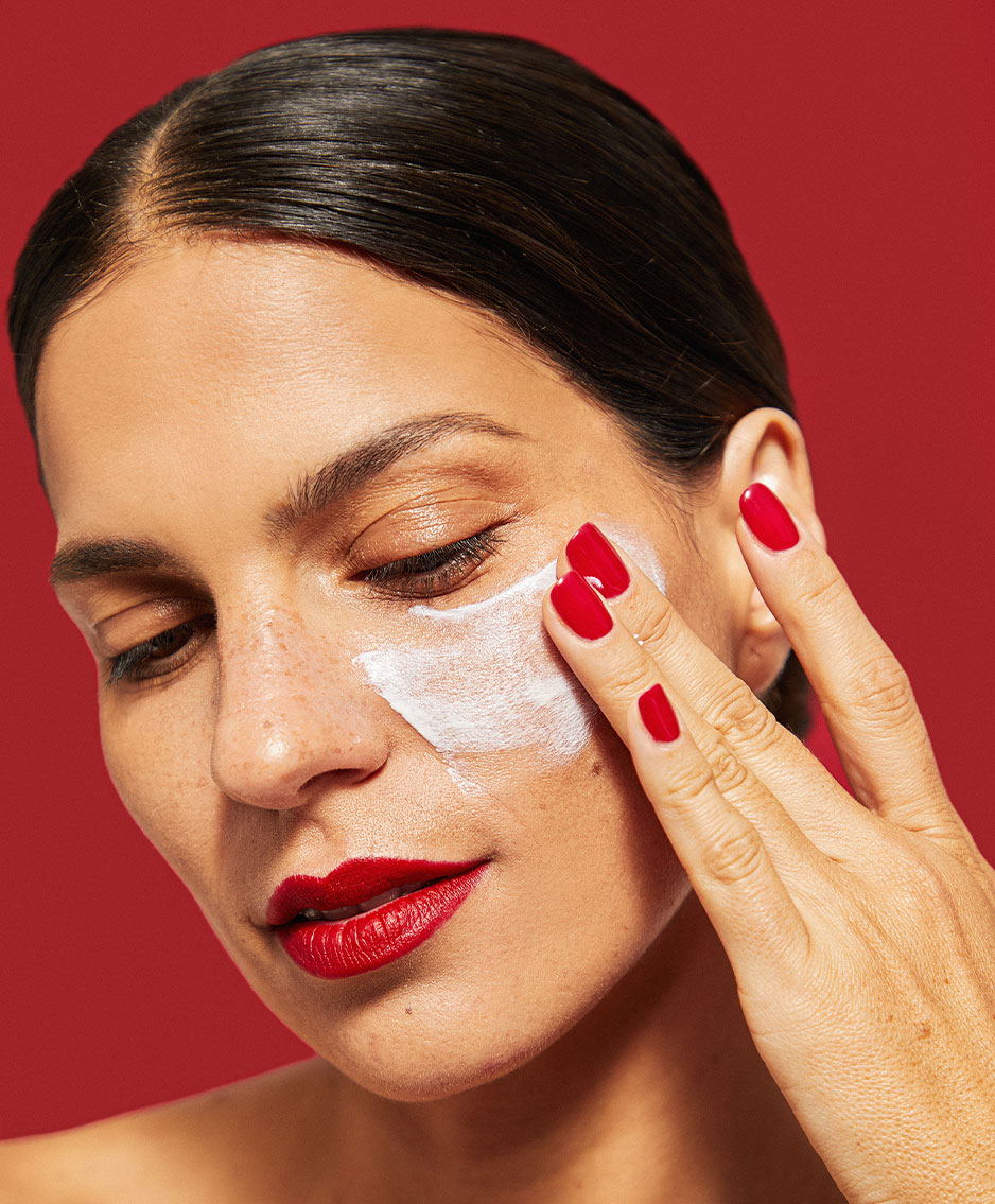 Woman putting moisturiser on her skin