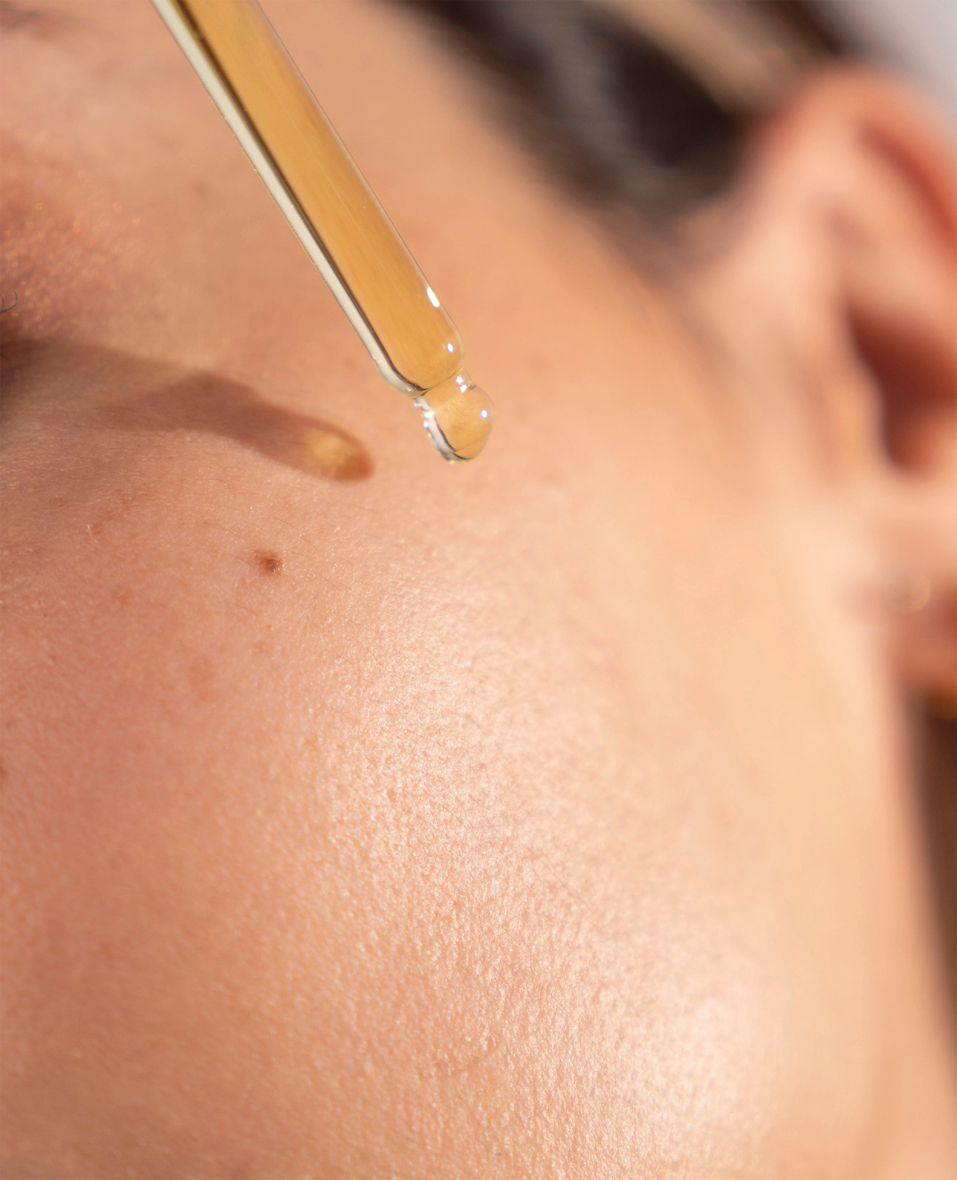 A person using an O Cosmedics correcto serum to repair a damaged skin barrier.